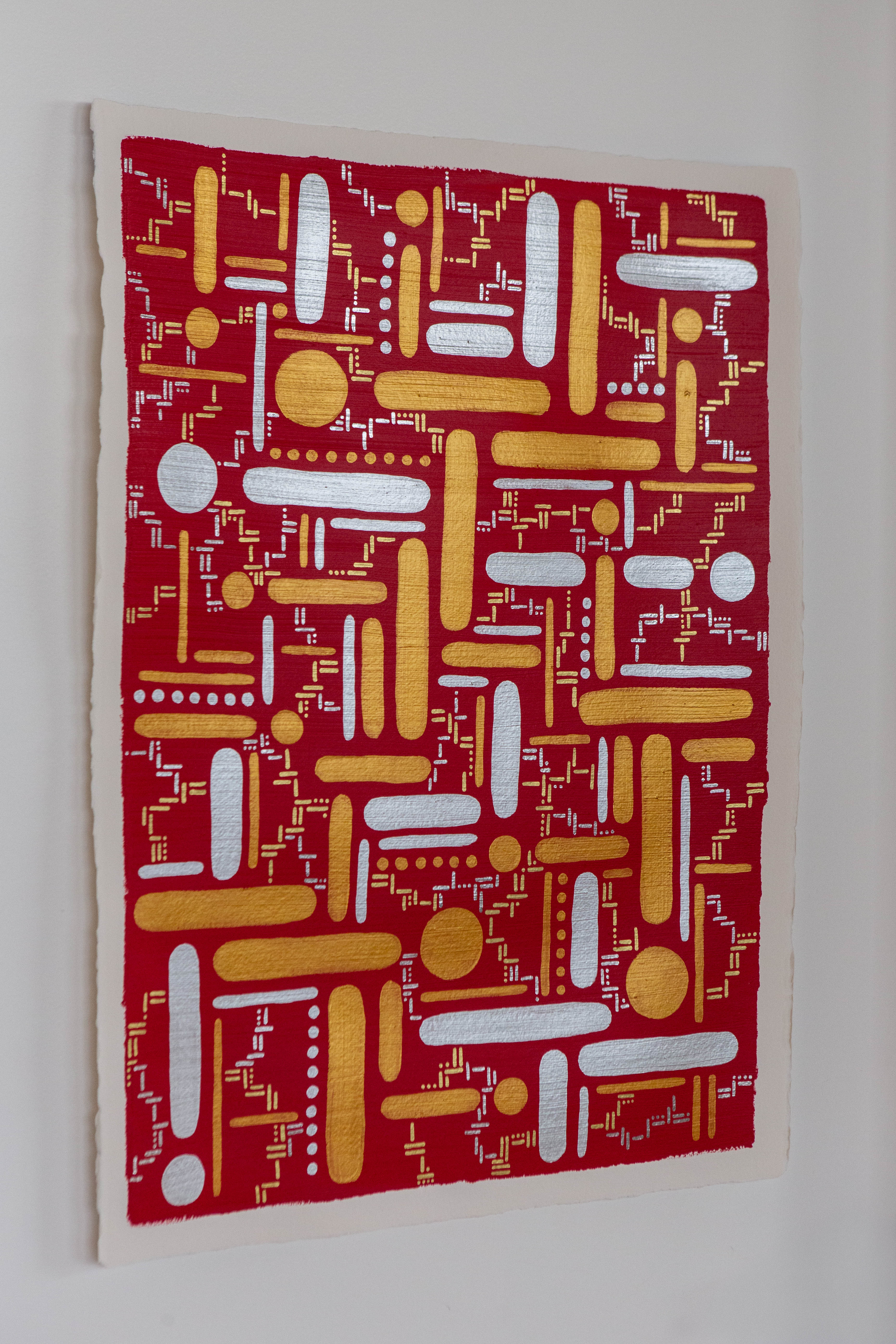 Destiny: Red artwork with yellow and white dots and straight lines, shown hanging on a pale wall.