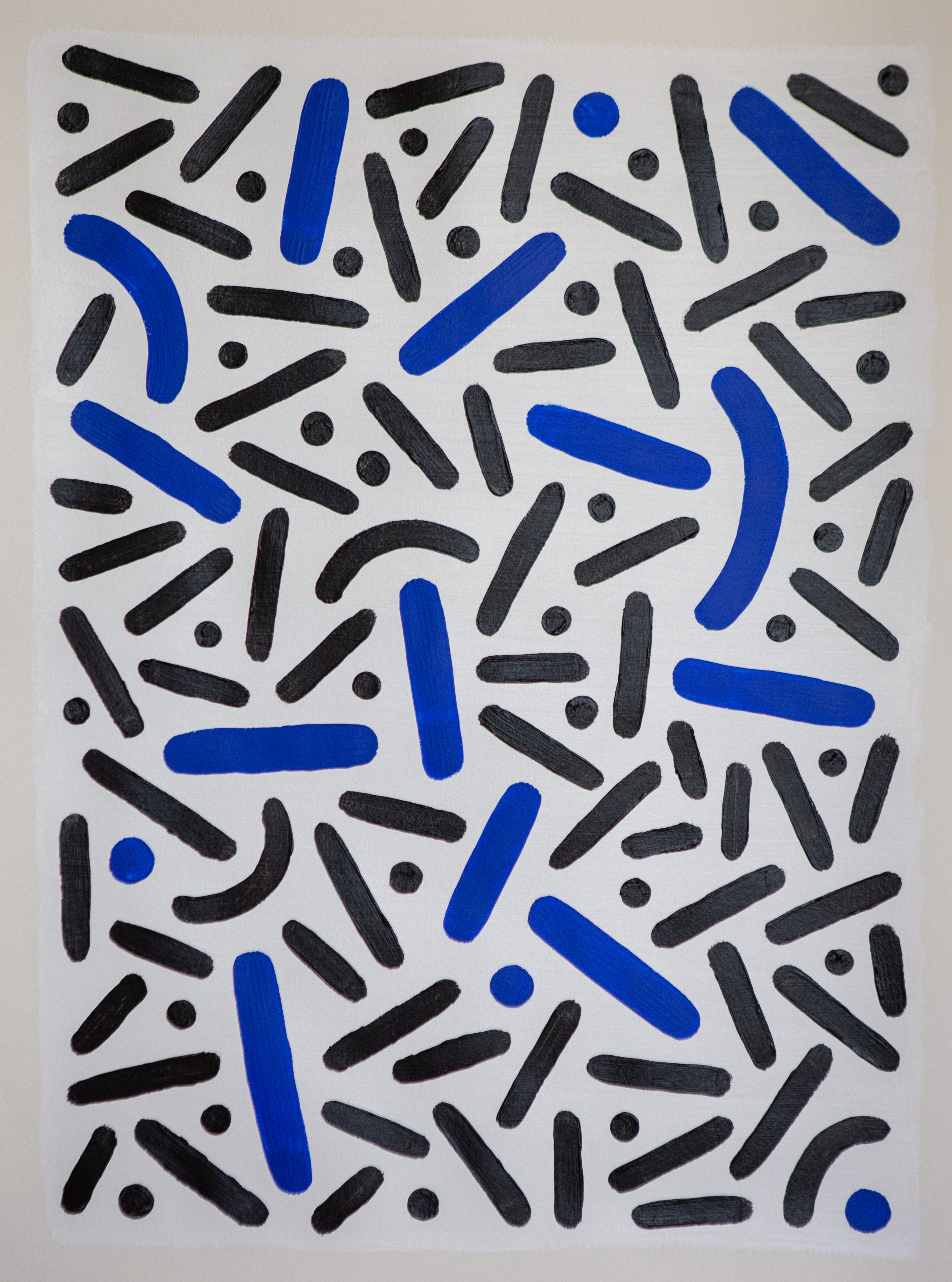 Blue and black dots and curves scattered over a pale vertical background.