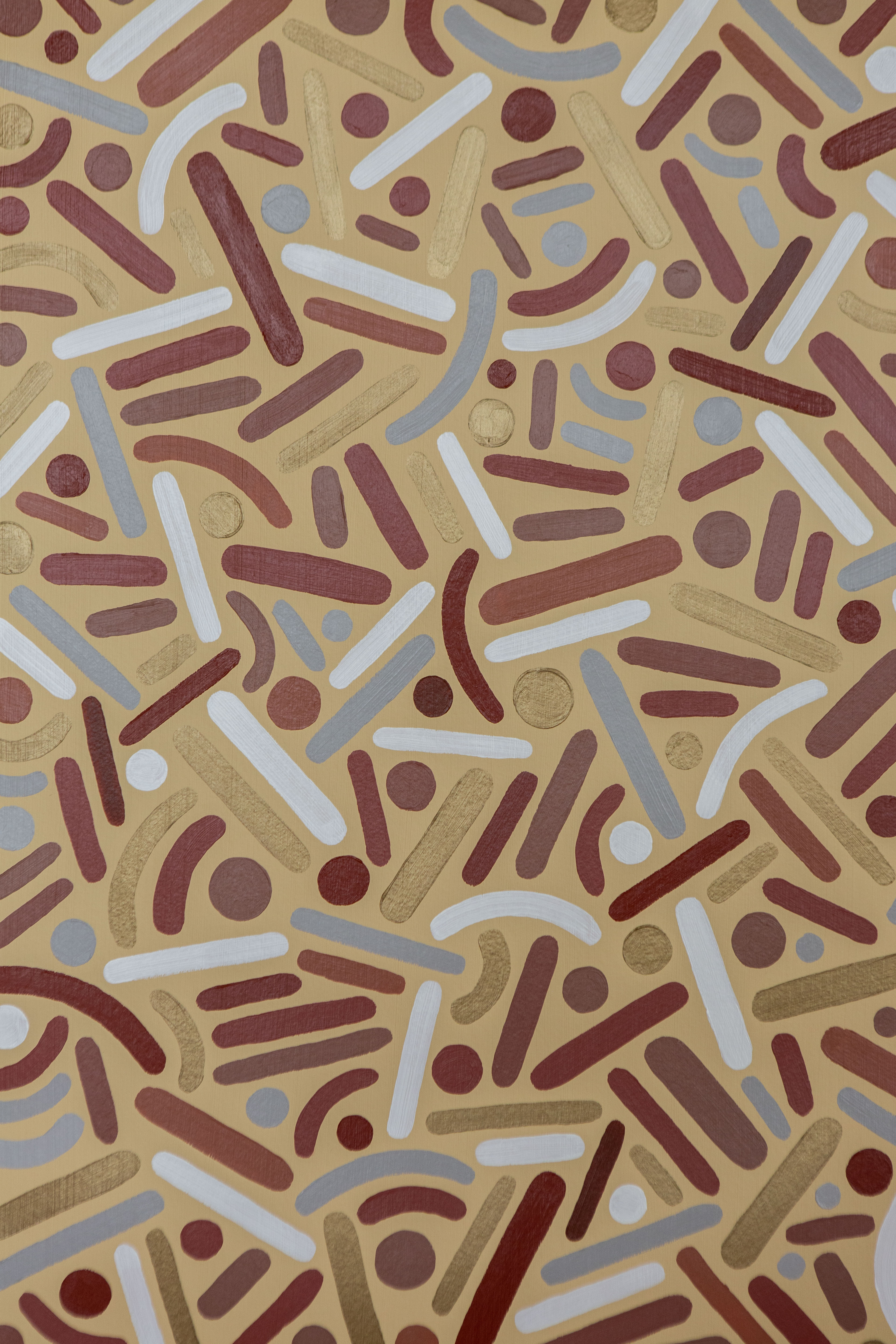 Desert Frequency: Close-up of brown, gold, cream, and pale-blue dots and curves on a light background.