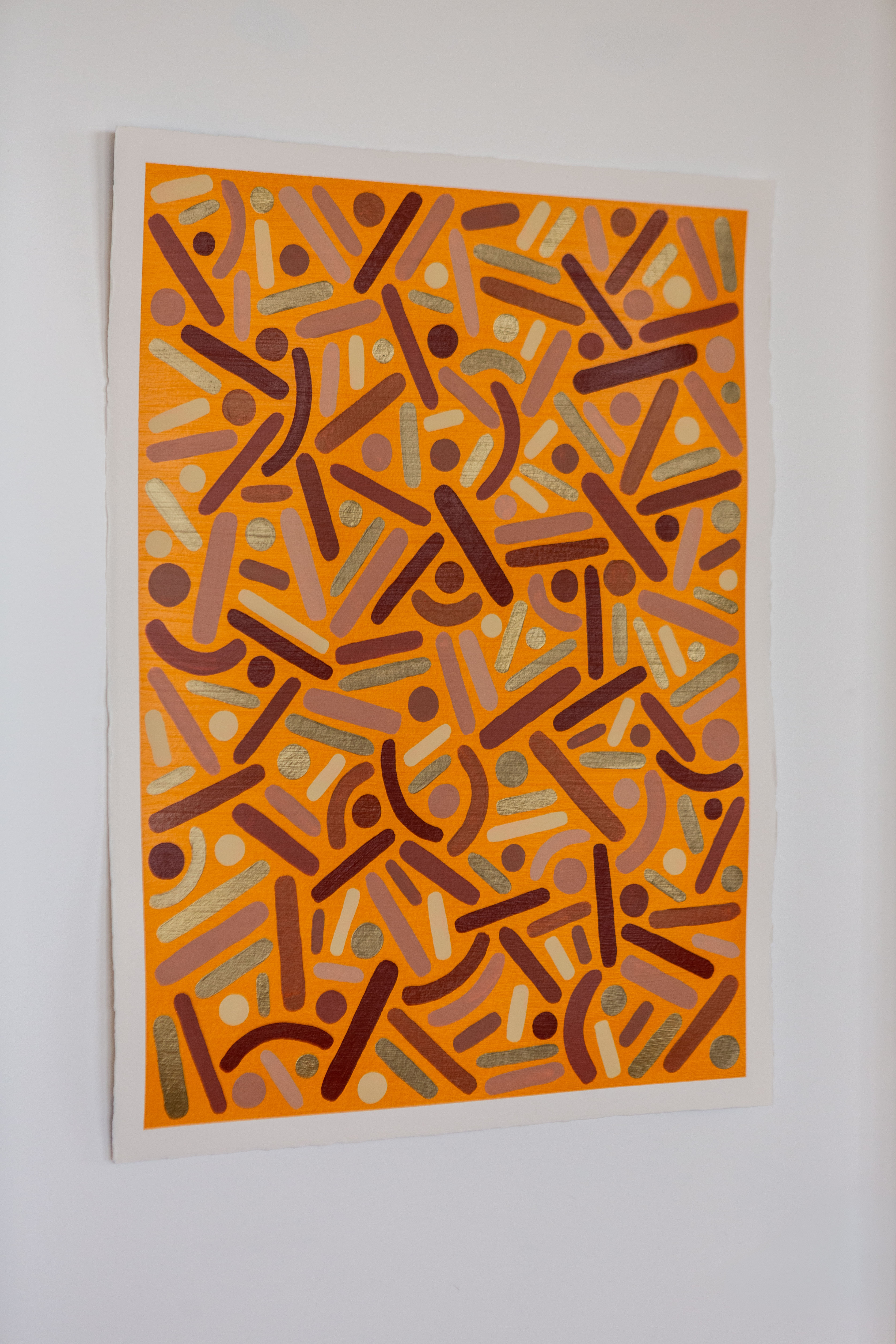 Canyon Frequency: Orange dots-and-curves artwork hanging on a pale wall.