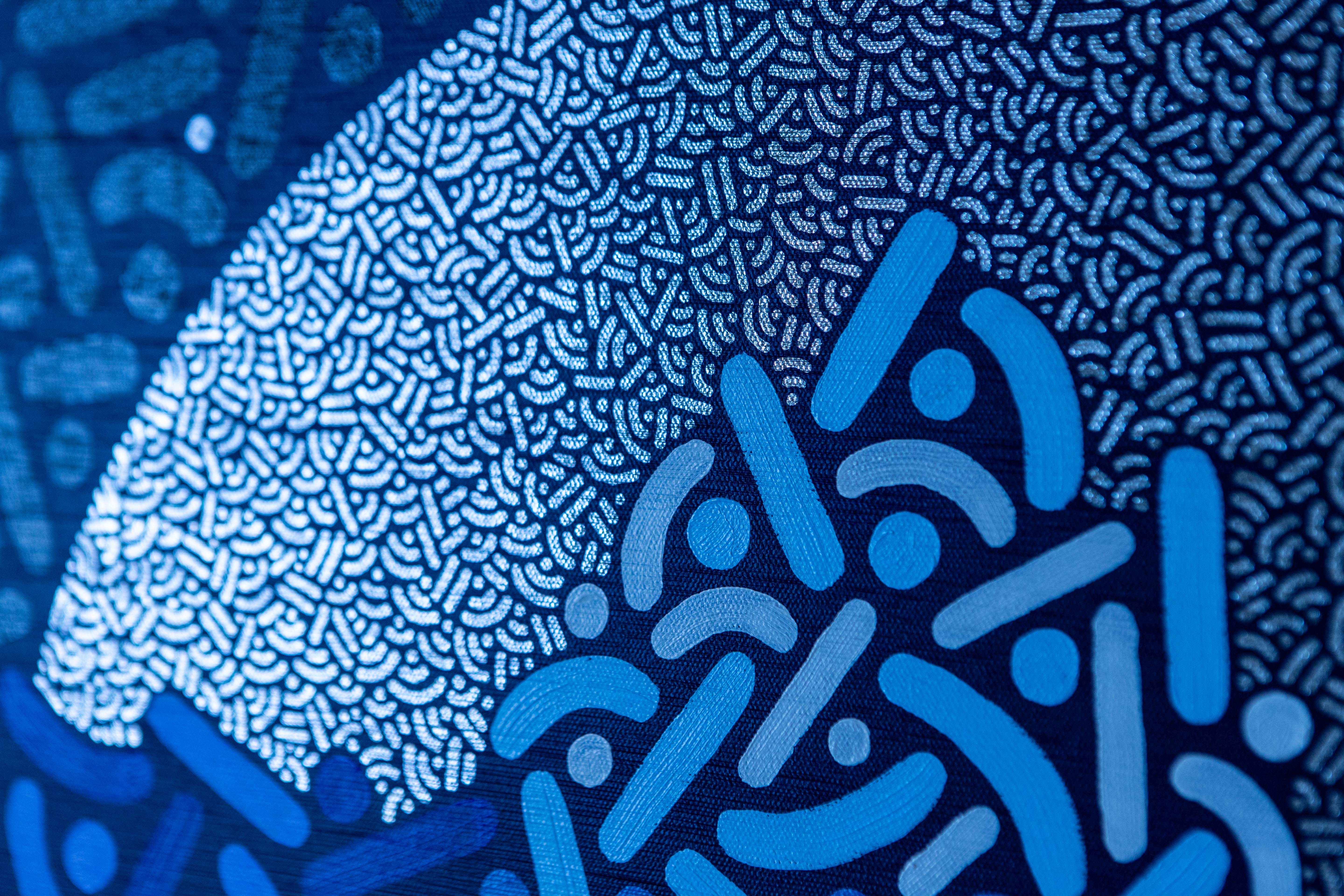 Moonlit Iceberg: Detail of a pale circular moon behind blue and turquoise patterned forms.