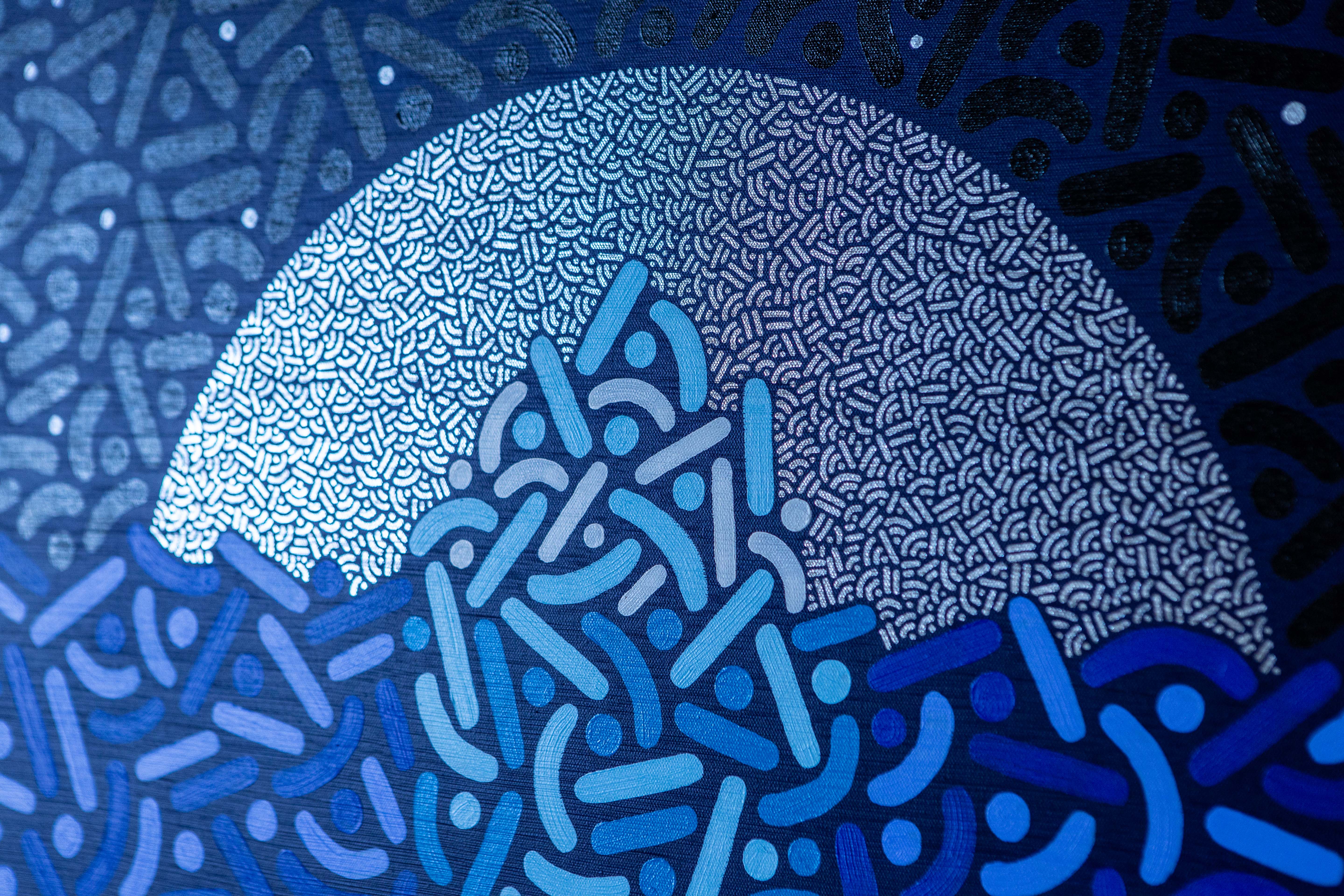 Moonlit Iceberg: Detail of a pale circular moon behind blue and turquoise patterned forms.