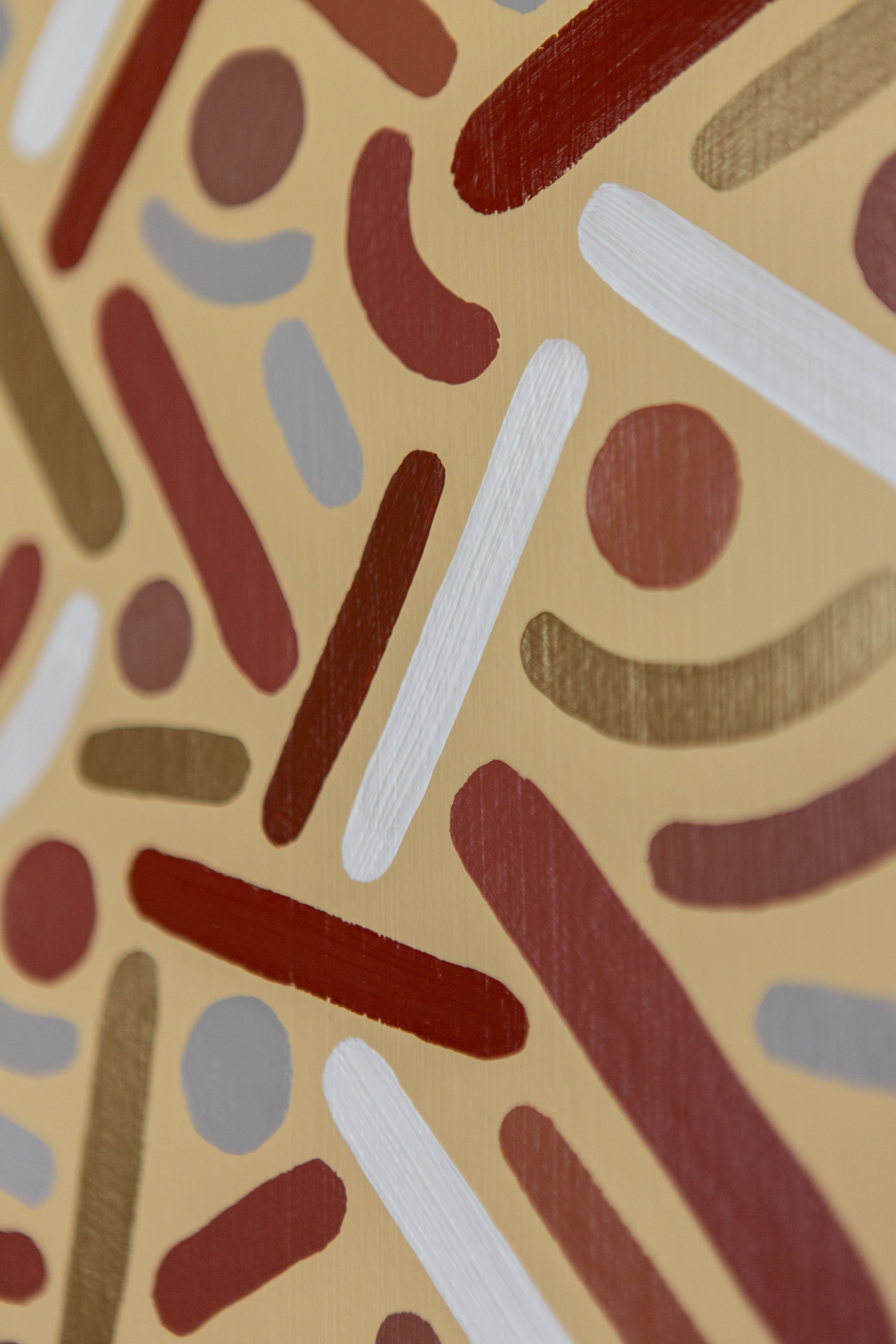 Desert Frequency: Close-up of brown, gold, cream, and pale-blue dots and curves on a light background.