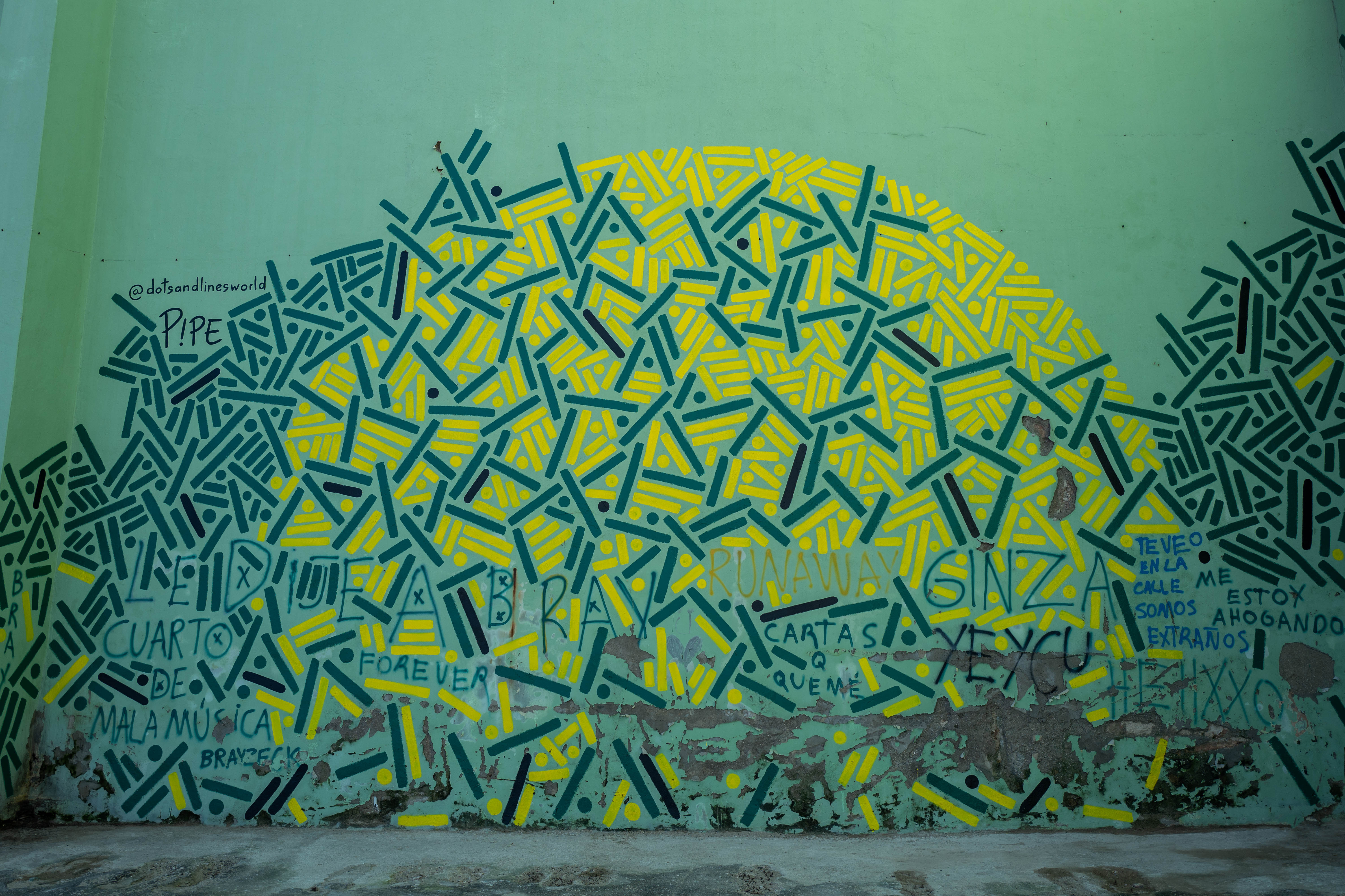 “Nature Finds a Way,” a large-scale turquoise and yellow mural by Pipe Yanguas, presented during the 15th Havana Biennial in Havana, Cuba.