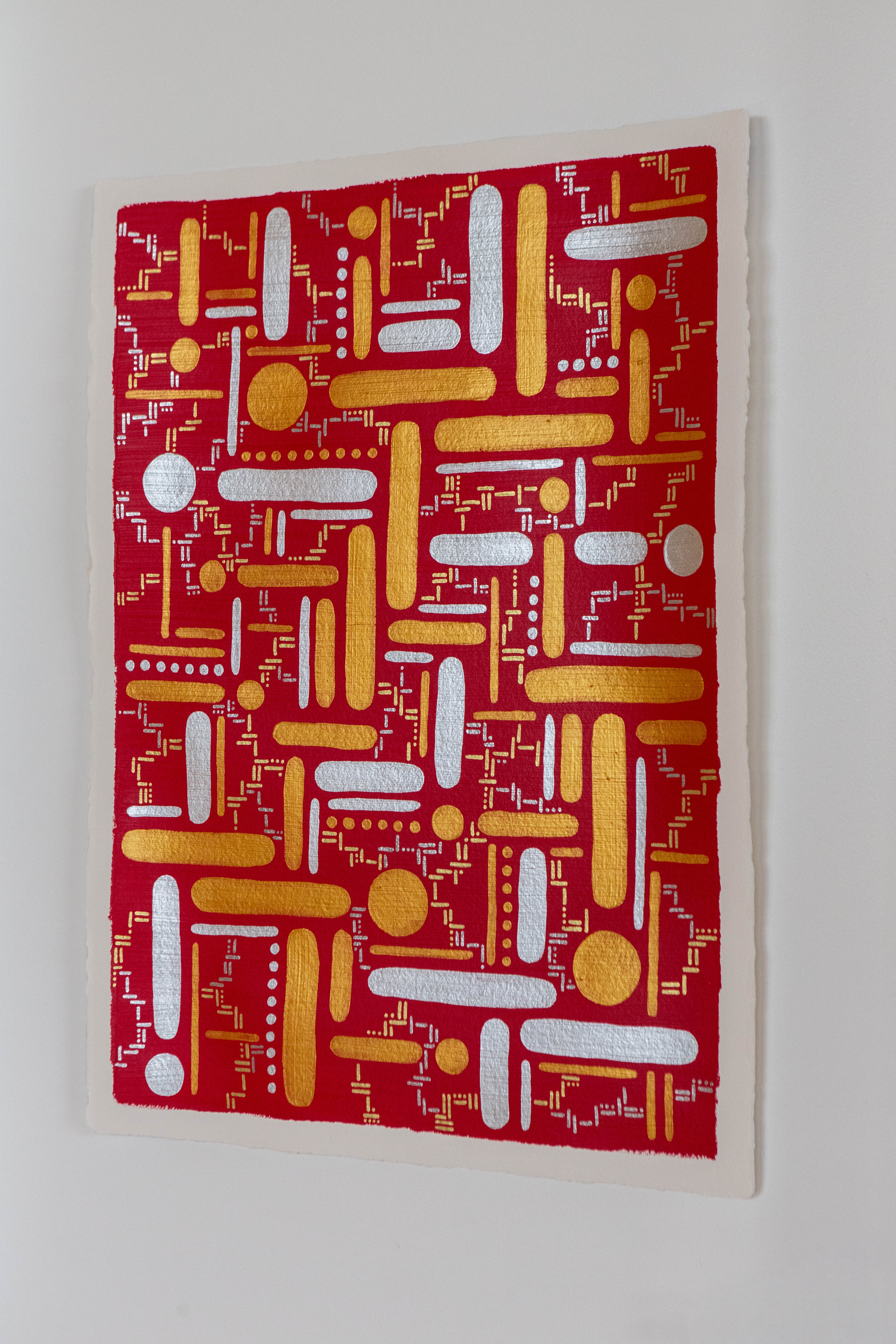 Destiny: Red artwork with yellow and white dots and straight lines, shown hanging on a pale wall.
